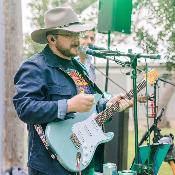 Robert Puffe playing guitar at a live show